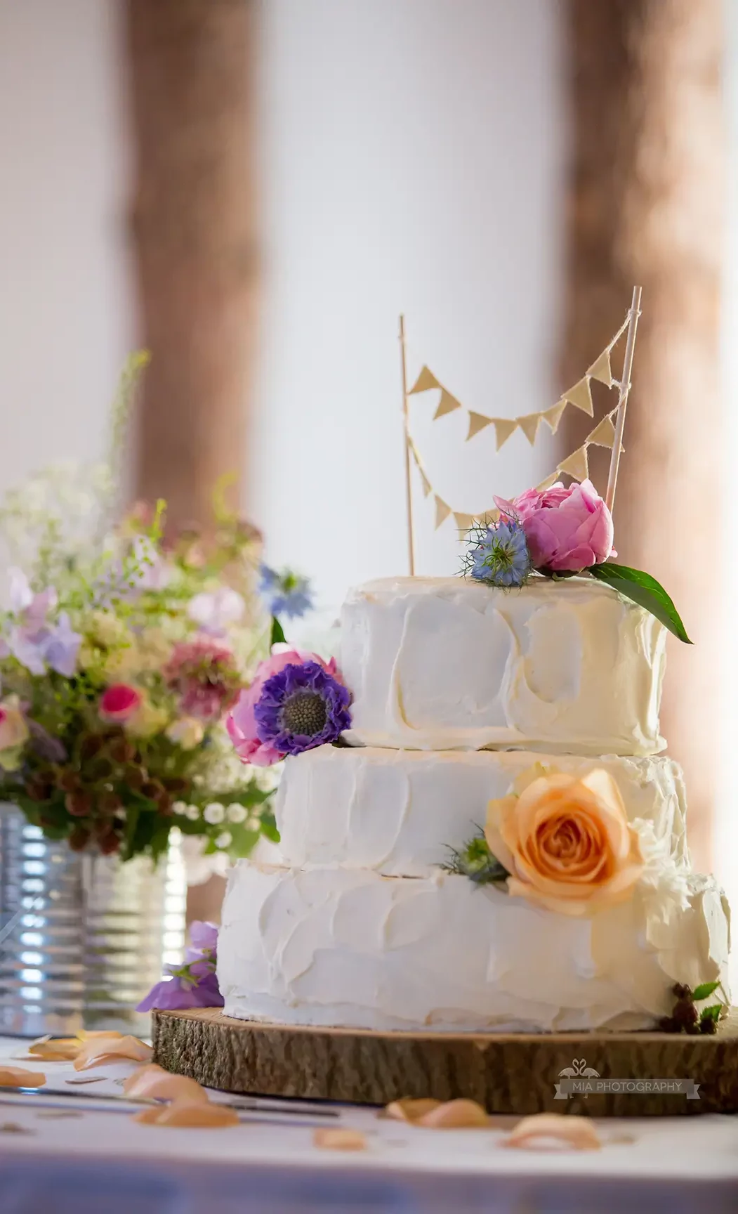 Clock Barn Buttercream wedding cake with flower decorations